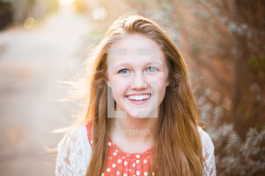 the smiling face of a senior girl in high school 