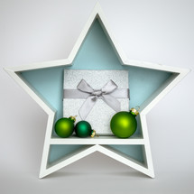 Green Christmas ornaments and gift in a star 