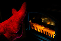 Close up of Stretching Feet in Red Socks by Fireplace