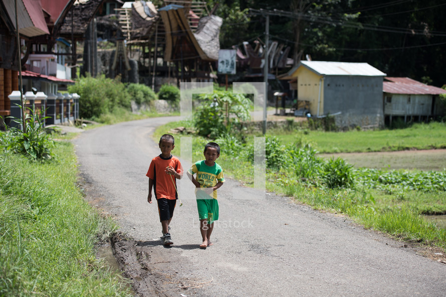 children walking on a street in Toraja 