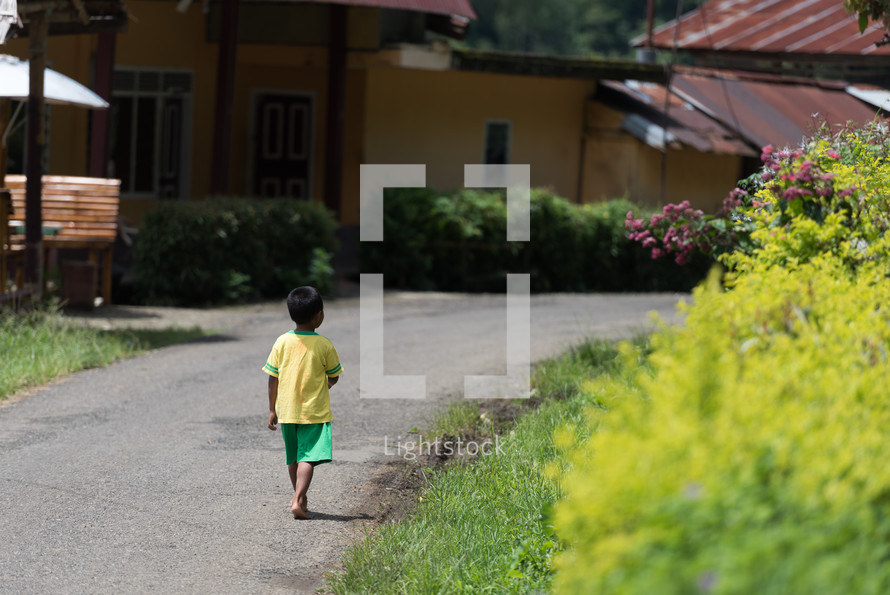 boy walking on the streets of Toraja 