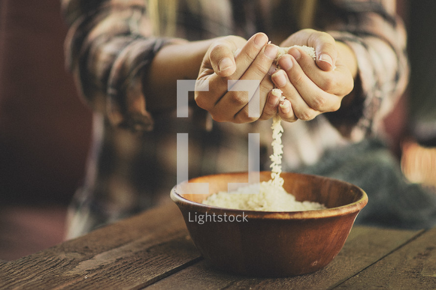 cupped hands holding rice grains 