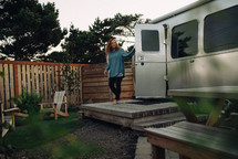 a woman stepping out of a camper 