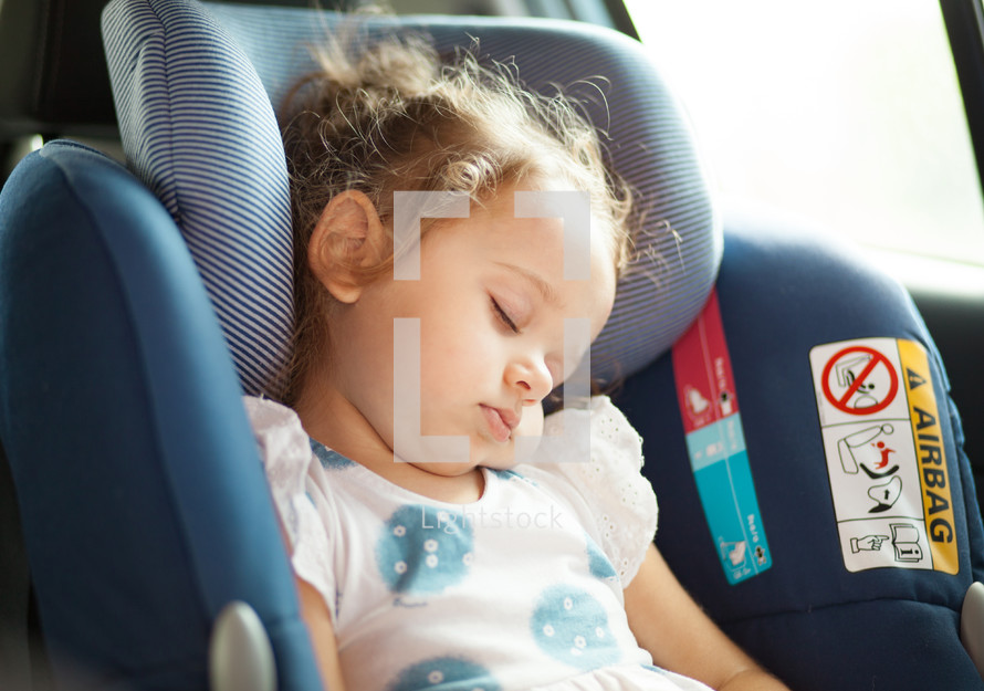 girl napping in a carseat 