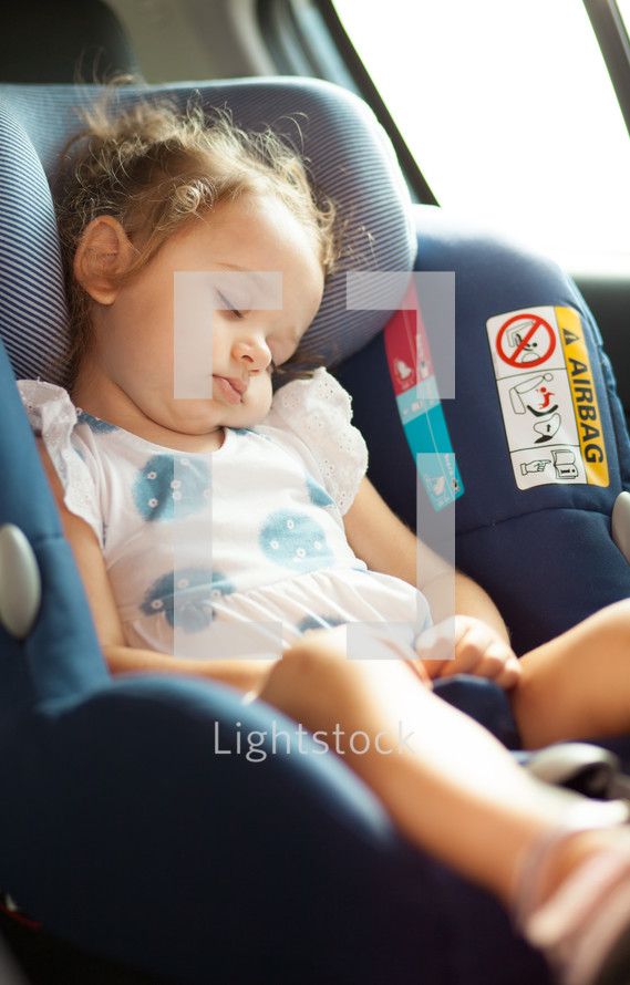 toddler sleeps in a car seat 