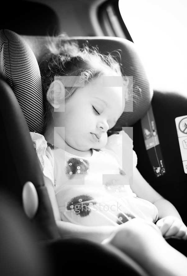 girl napping in a carseat 