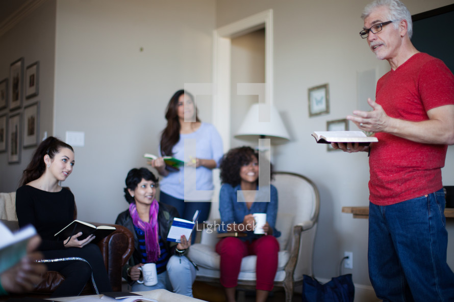 A man leading a small group in a Bible study.