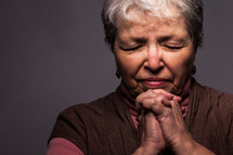 headshot of a woman in prayer 