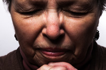 face of a woman in prayer