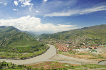 Mtkvari and Aragvi river through mountains and a village.