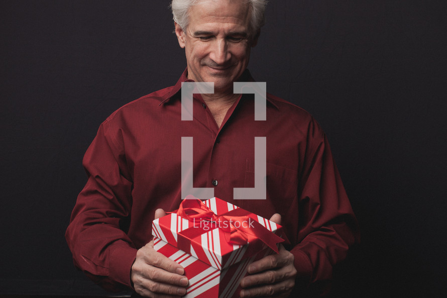 man holding a Christmas present 