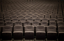 Rows of seats in an empty auditorium.
