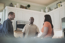 people in conversation in a kitchen at a small group Bible study 