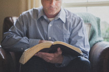 Man reading the bible.