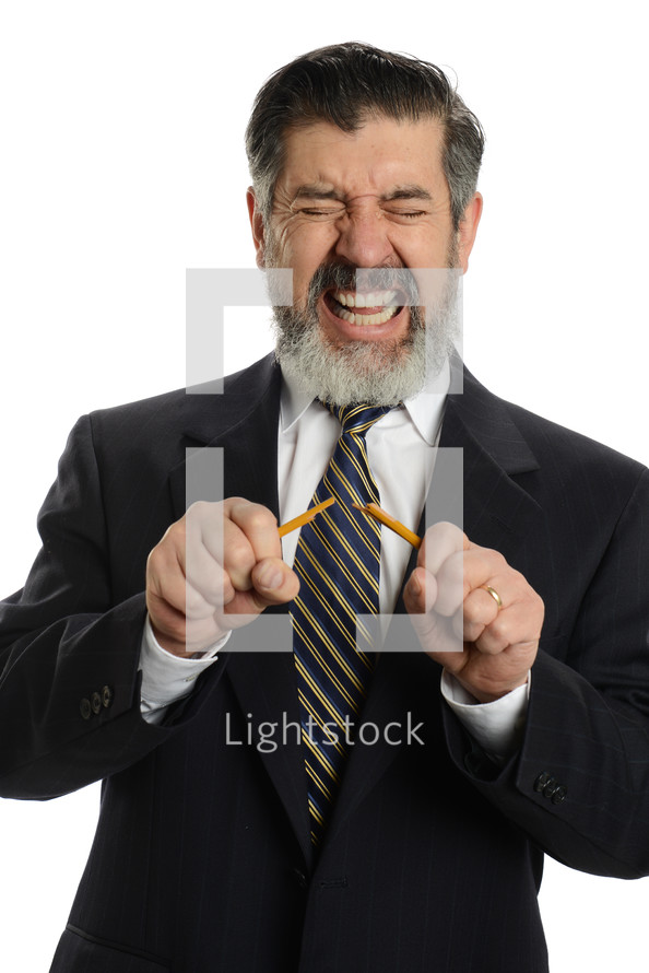 frustrated businessman breaking a pencil 