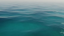CGI, Blue Ocean Surface With Calm Waves At Daytime. Seamless Loop. pullback	