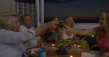People enjoying food and wine during home dinner