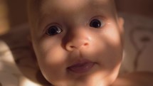 Indoor portrait of smiling baby girl