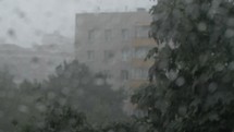 Heavy rain pouring outside the window