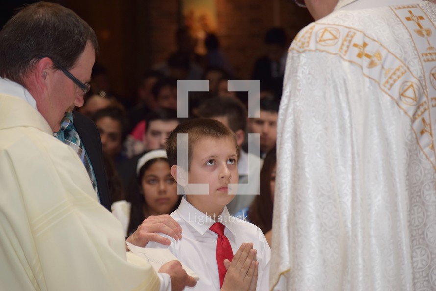 a boy receiving first communion 