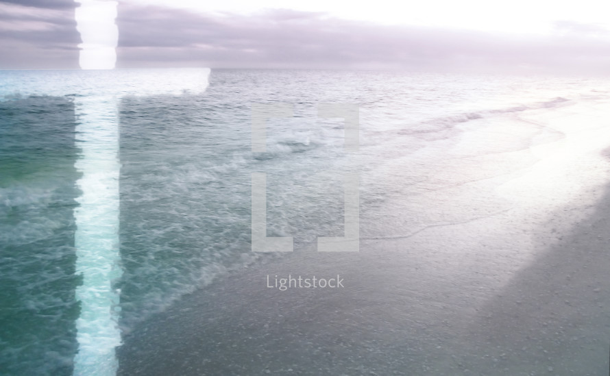 light cross superimposed on calm, soft-focus beach scene in turquoise green and purple 