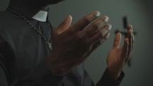 Hands of Black Catholic Priest Speaking on Liturgical Service in Church