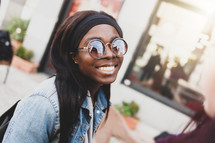 Portrait of a young smiling girl of African ethnicity in outdoor.