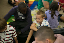 A man ministering to young kids