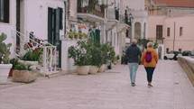 Old Couple walking in the streets of Italy