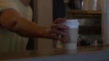 Barista Places Coffee On Counter