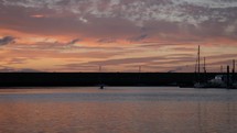 Person Paddling In Canoe Through Dun Laoghaire Harbour at Sunset, County Dublin, Ireland