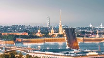 aerial view of russian city with illuminated drawbridge and historic architecture at twilight 4K drone shot
