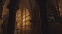 Monastery hallway in gothic style with stained glass light