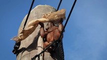 Female Orangutan Putting Sack Over Her Head Like a Blanket
