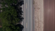 An overhead view of a country road. 