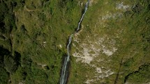 Aerial Drone View Of Impressive Virgin Waterfalls Cascading On Rocky Forest Mountains In Baños, Ecuador.	