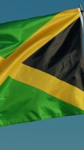 Jamaica Flag Waving With Blue Sky Background