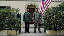 American Military Man And Veteran Greeting Father And Son In Front Of House
