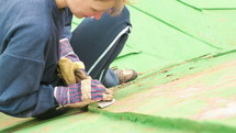 a woman repair a roof 