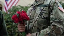 Soldier Gives Flowers to Veteran After His Honorable Service at the War Front