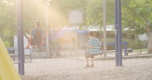 Children swinging on a playground.