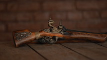 Pirate pistol on table in old tavern