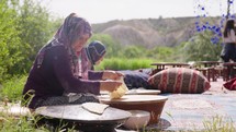 Turkey, Goreme, May 2023: Turkish elderly woman making falafel flat bread. Traditional turkish cuisine
