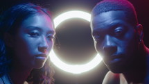 Neon Portrait of Young Man and Woman against Ring Light