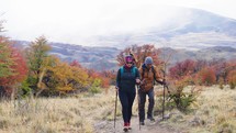 The hikers walking in the mountain on fall season background. Slow motion
