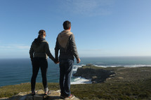 Couple on mountain cliff