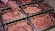 Fresh chicken meat section in a grocery store.
