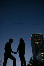 Couple holding hands at sunset 