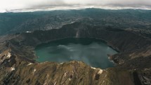 Panoramic View Of Quilotoa Lake And The Volcano Crater In Ecuador. Aerial Shot	