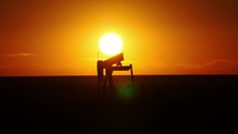 Silhouette of an oil well pump rig at sunset